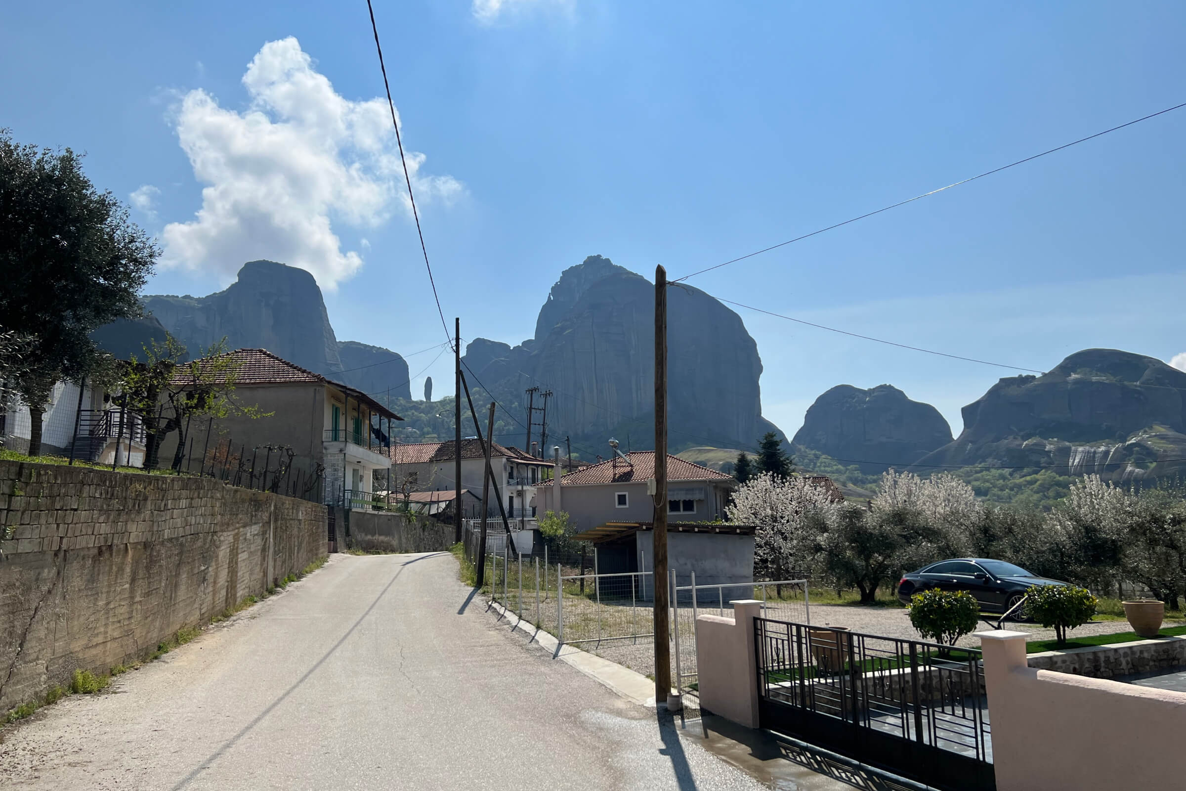 a street with houses and mountains in the background
