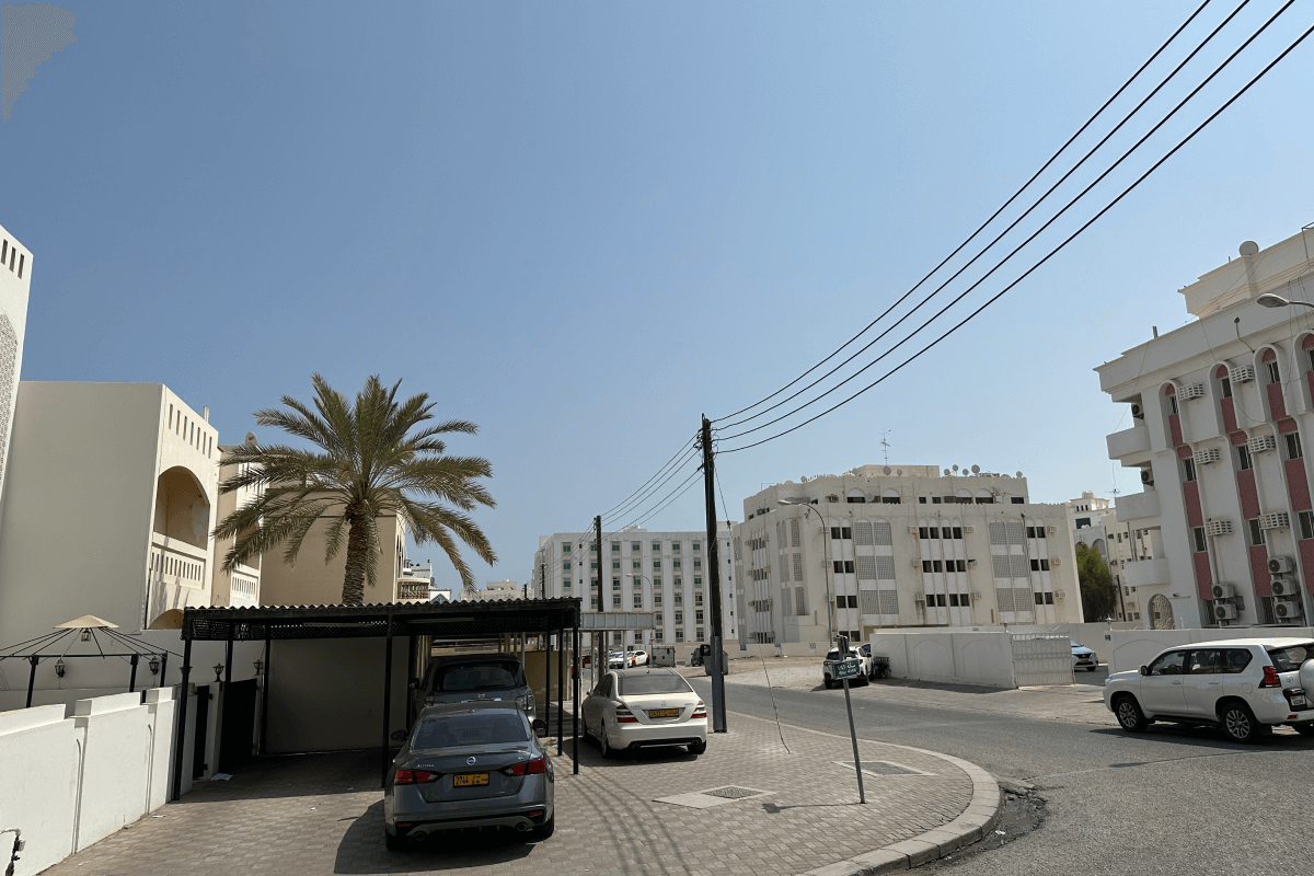 a city street with cars parked on the side of the road